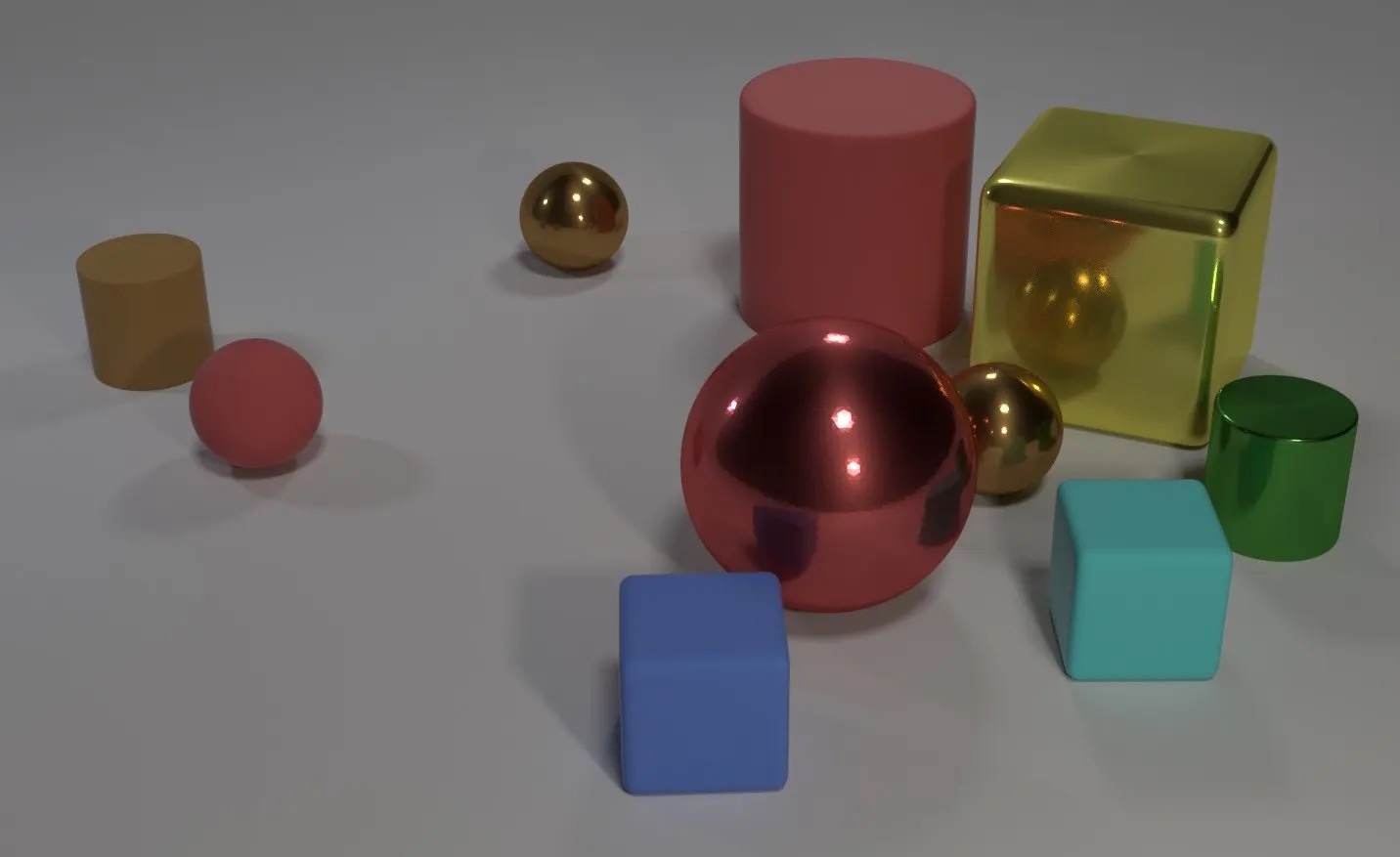 An assortment of three-dimension objects including several spheres and cuboid shapes, in multiple colors.They are laid out across a surface in non-regimented and non-ordered way.