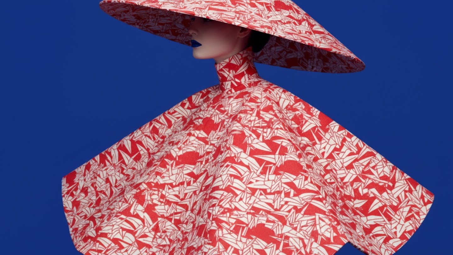 a stylized, cropped image of a person wearing a voluminous, high-collared garment and a wide-brimmed hat, all featuring a bold red and white origami crane pattern, against a solid bright blue background, with dark blue lipstick.