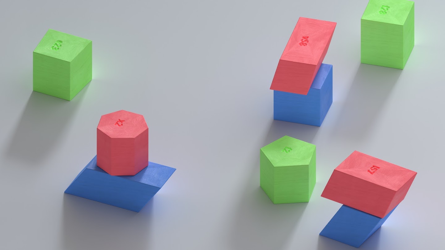 A collection of blocks on a grey surface. They are a mixture of shapes, coloured red, green, and blue. Some of the blocks are stacked on top of one another.