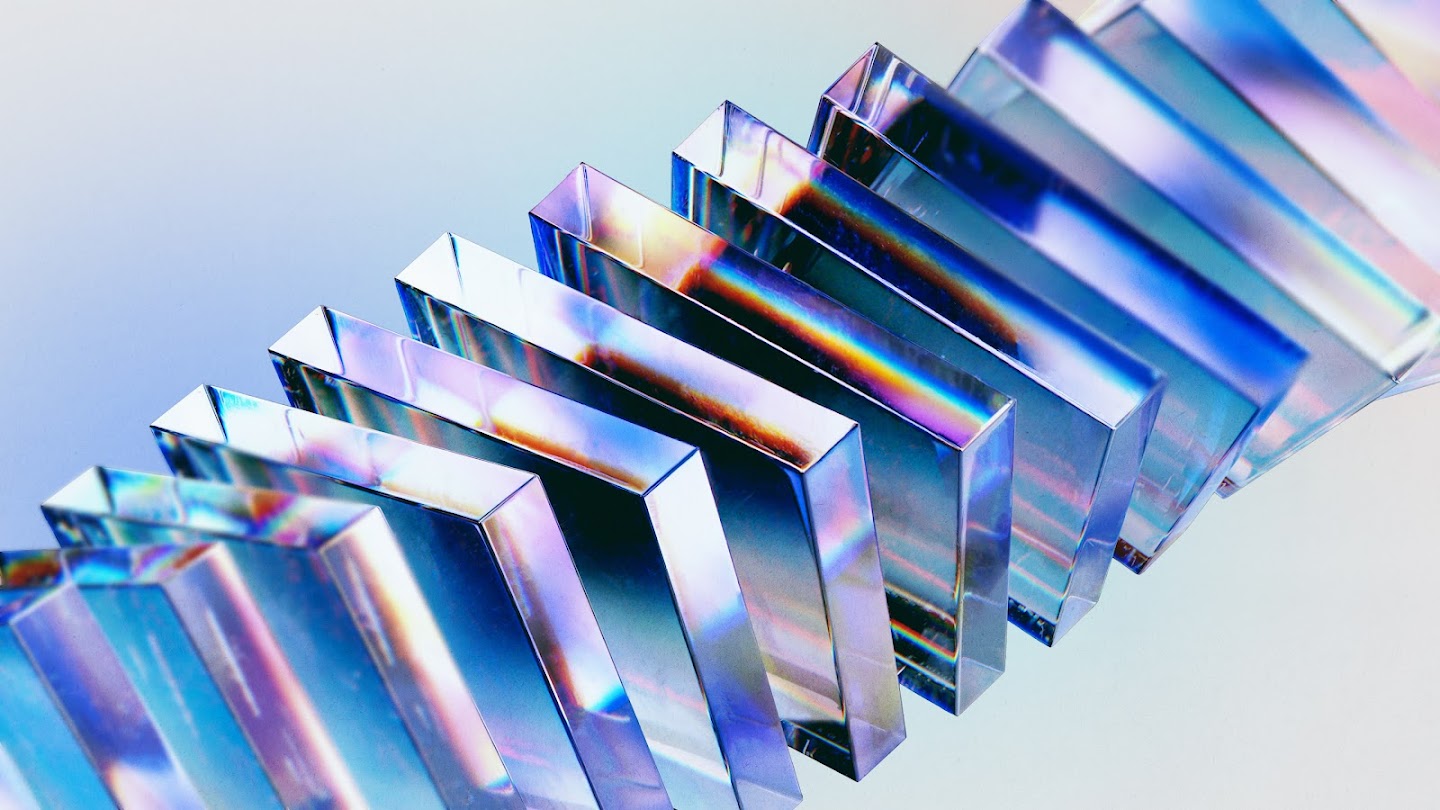 Featuring a sequence of transparent glass blocks, refracting hues of purple, blue and cyan, representing the frameworks which enable us to evaluate threats across the end-to-end cyber attack chain.